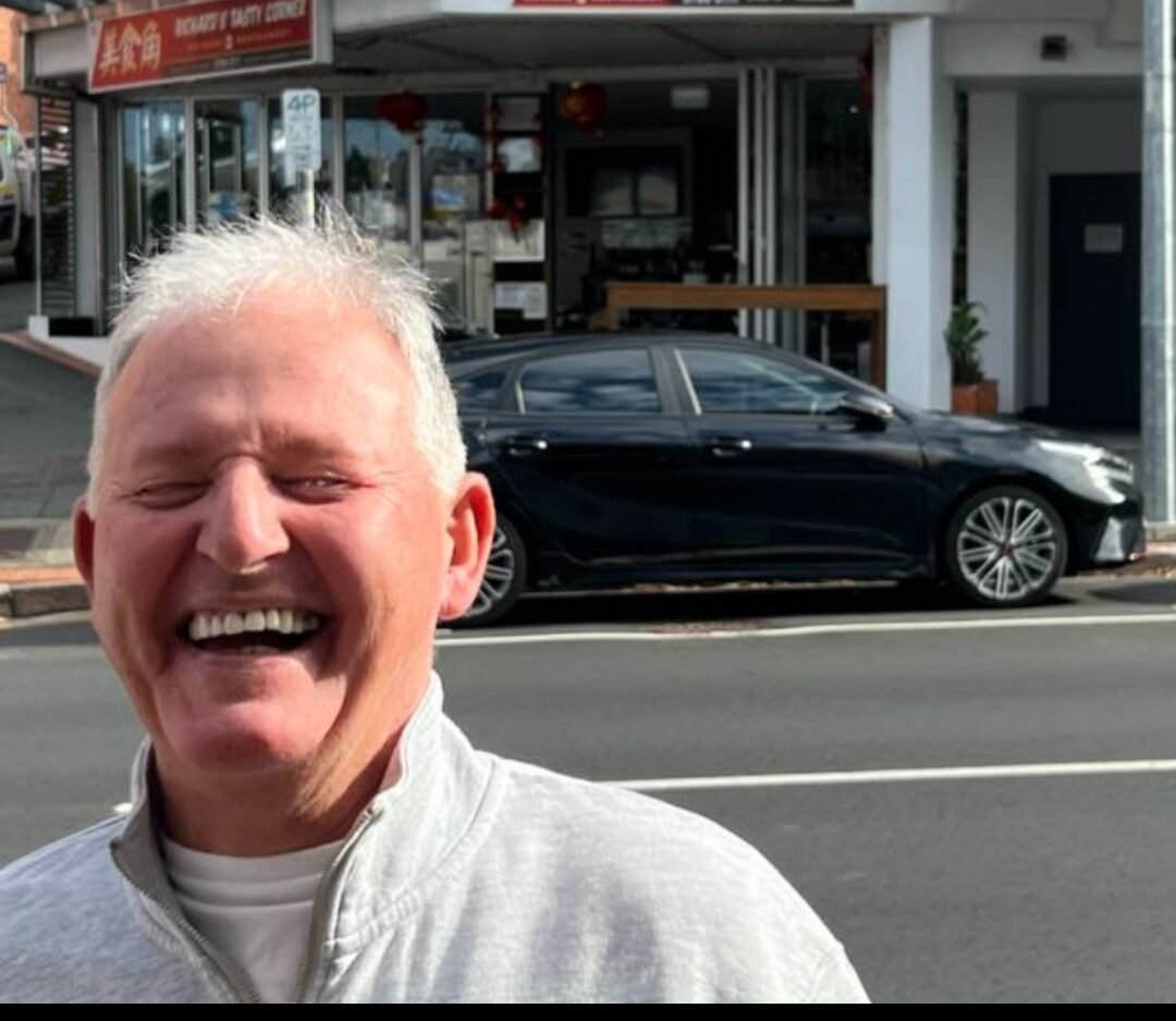 Aged care client having a laugh with his support worker